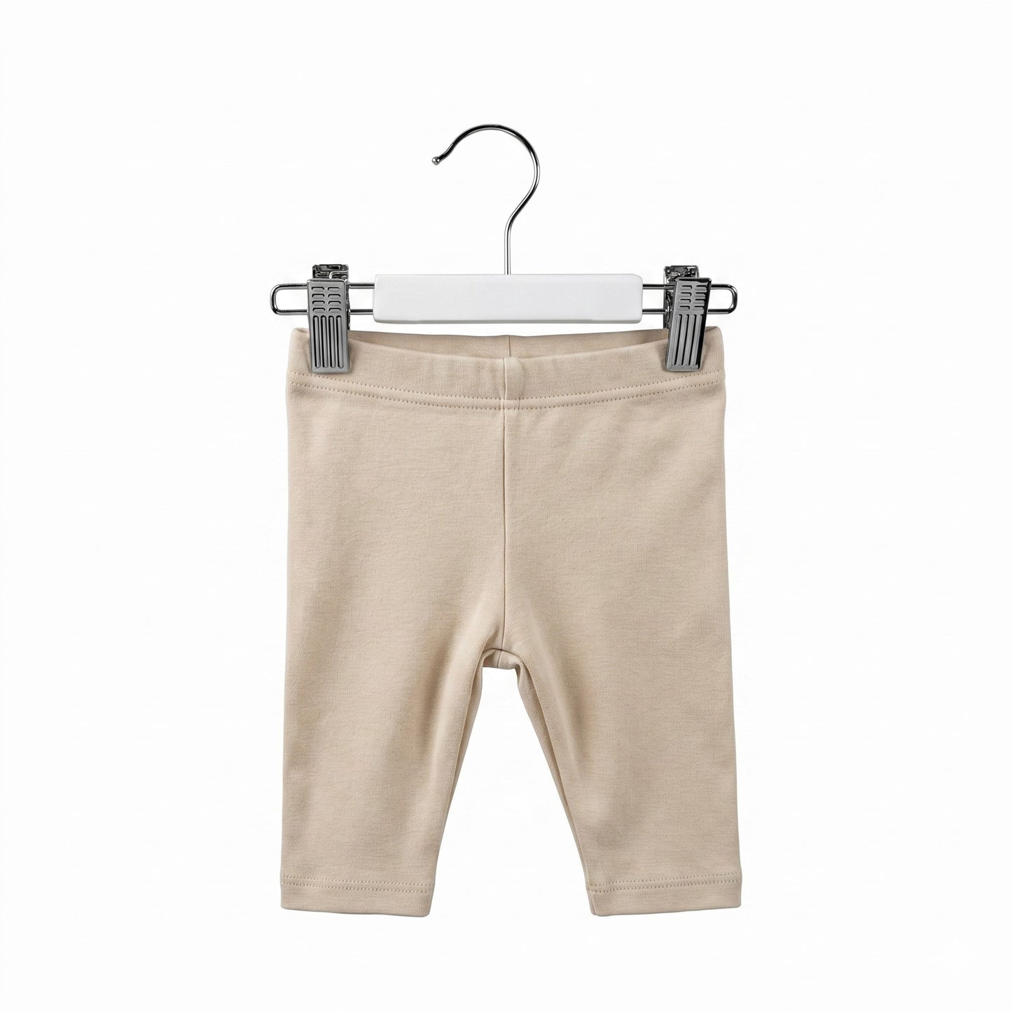 Beige baby leggings on a hanger against a white background