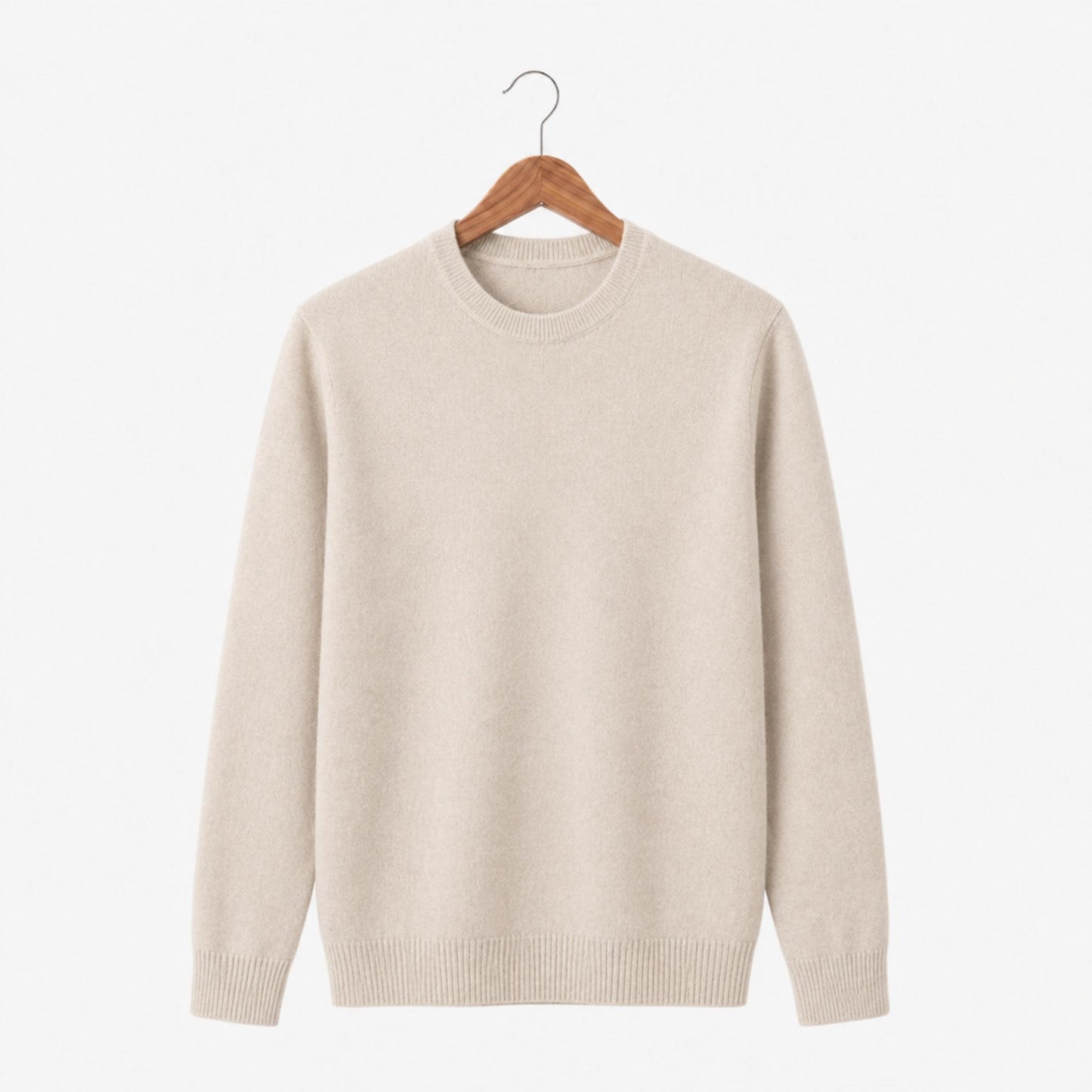 Beige sweater on a wooden hanger against a white background