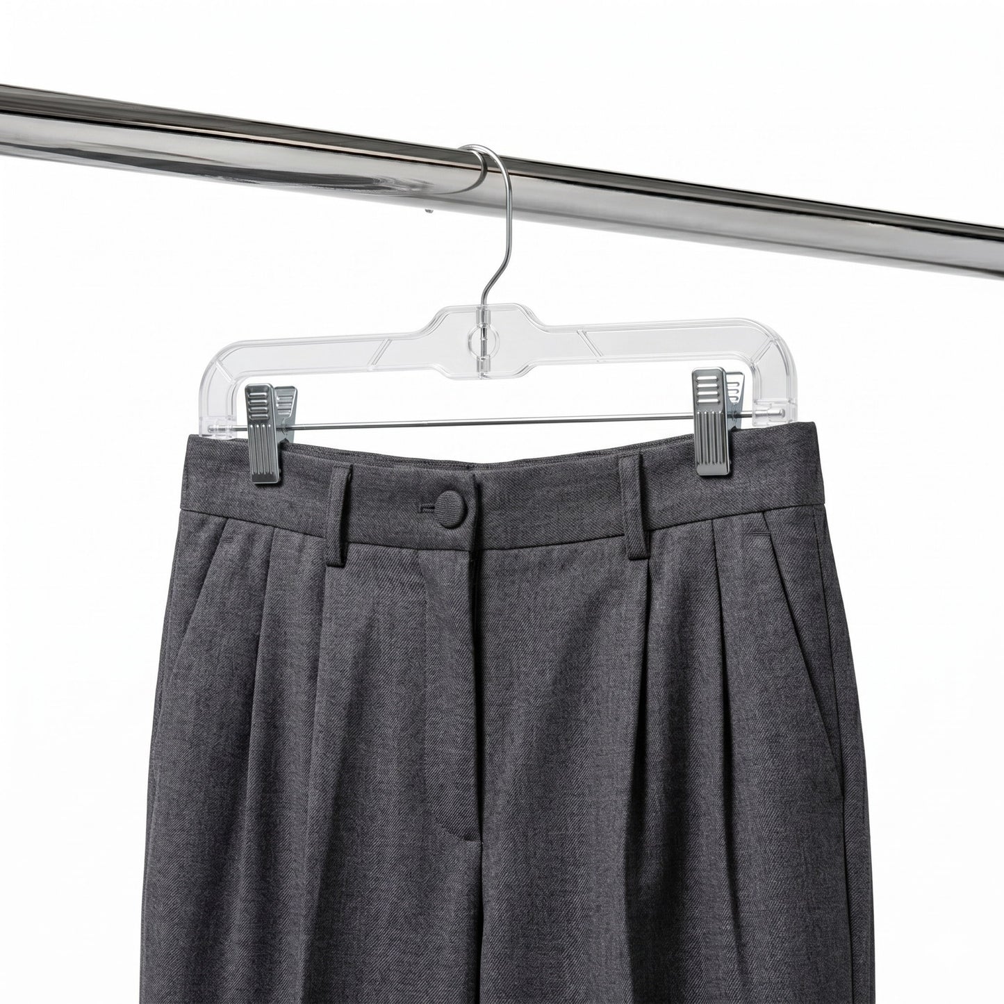 Gray pleated pants on a clear hanger against a white background