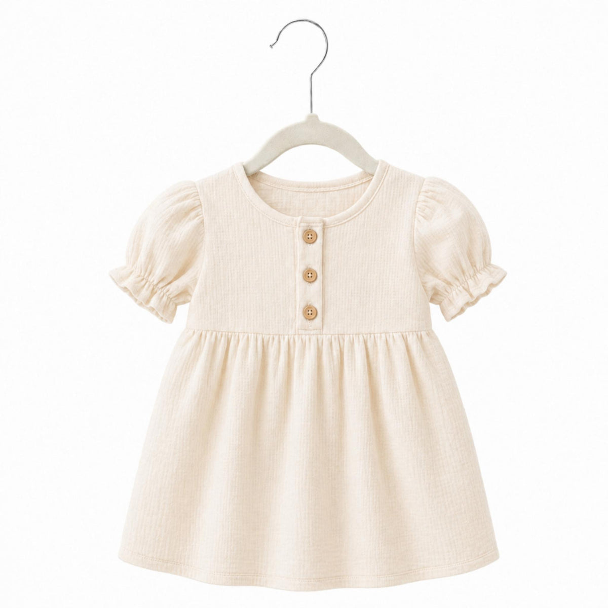 Beige baby dress on a hanger against a white background