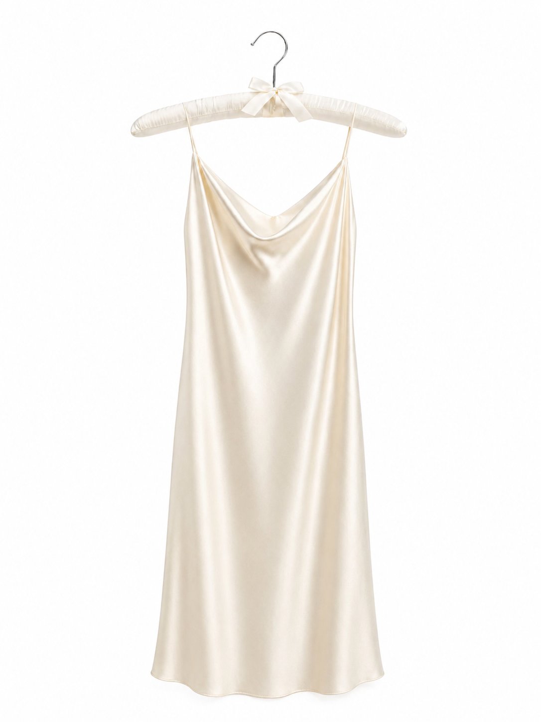 Cream-colored satin slip dress on a hanger against a white background