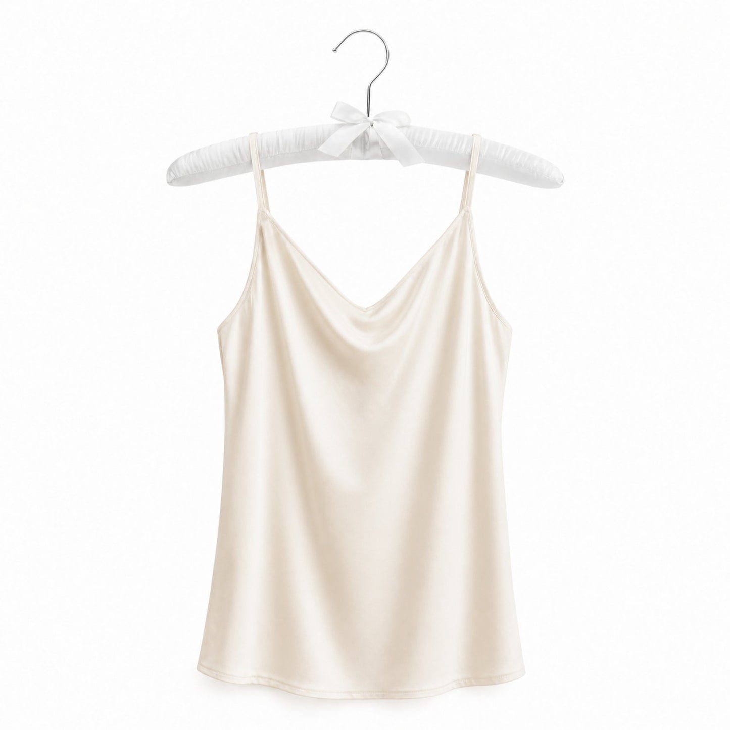 Beige satin camisole on a hanger against a white background