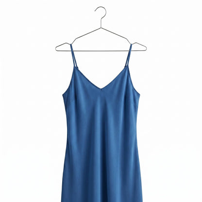 a Blue Dress hang on a metal chrome hanger against white background