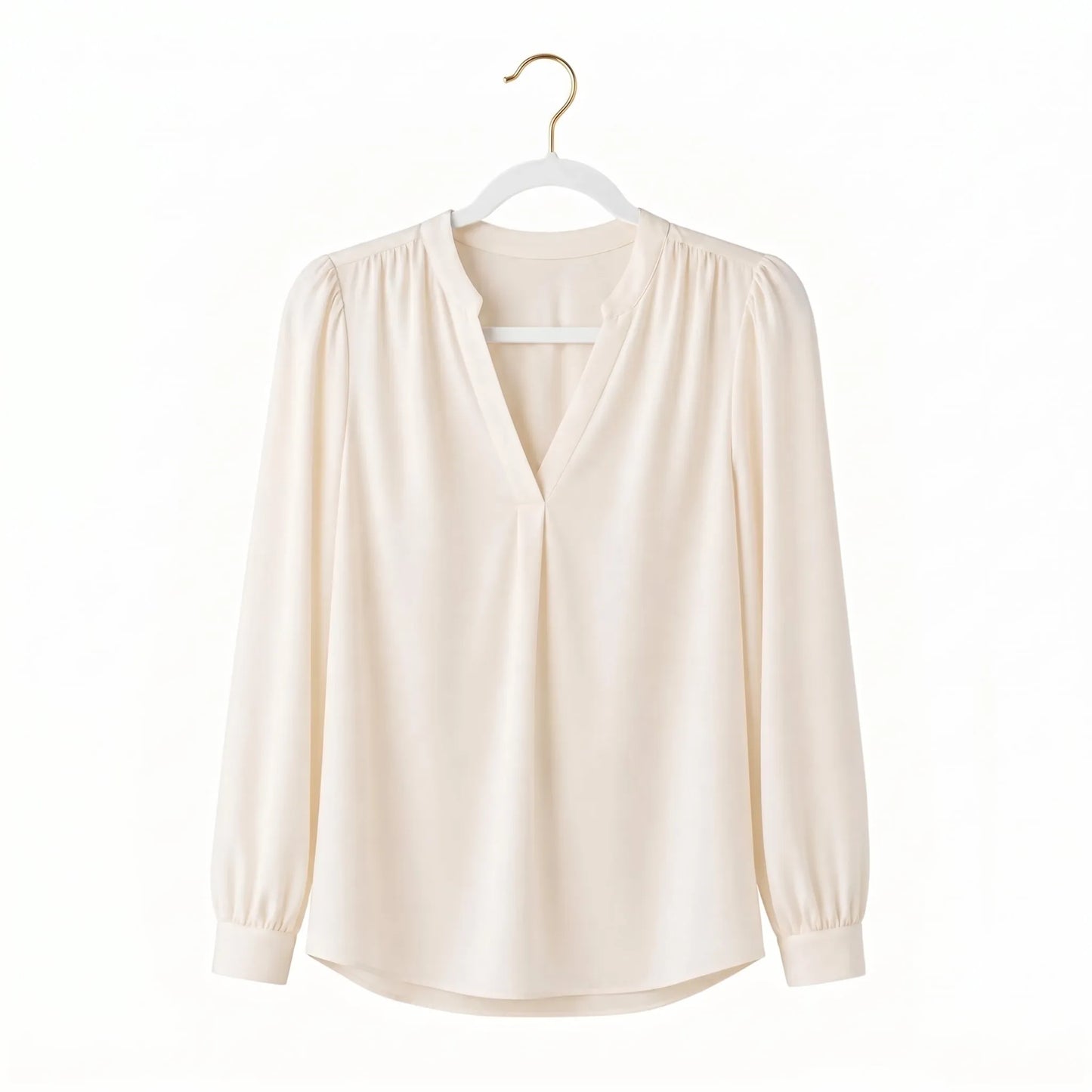 Beige blouse on a hanger against a white background
