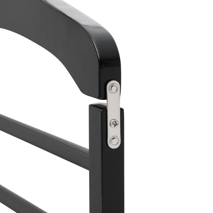 Close-up of a black metal chair armrest with a white background