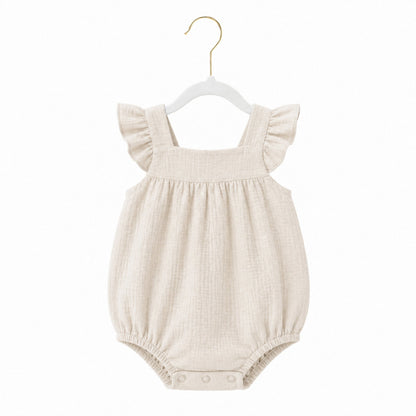 Beige baby romper with ruffled straps on a white background