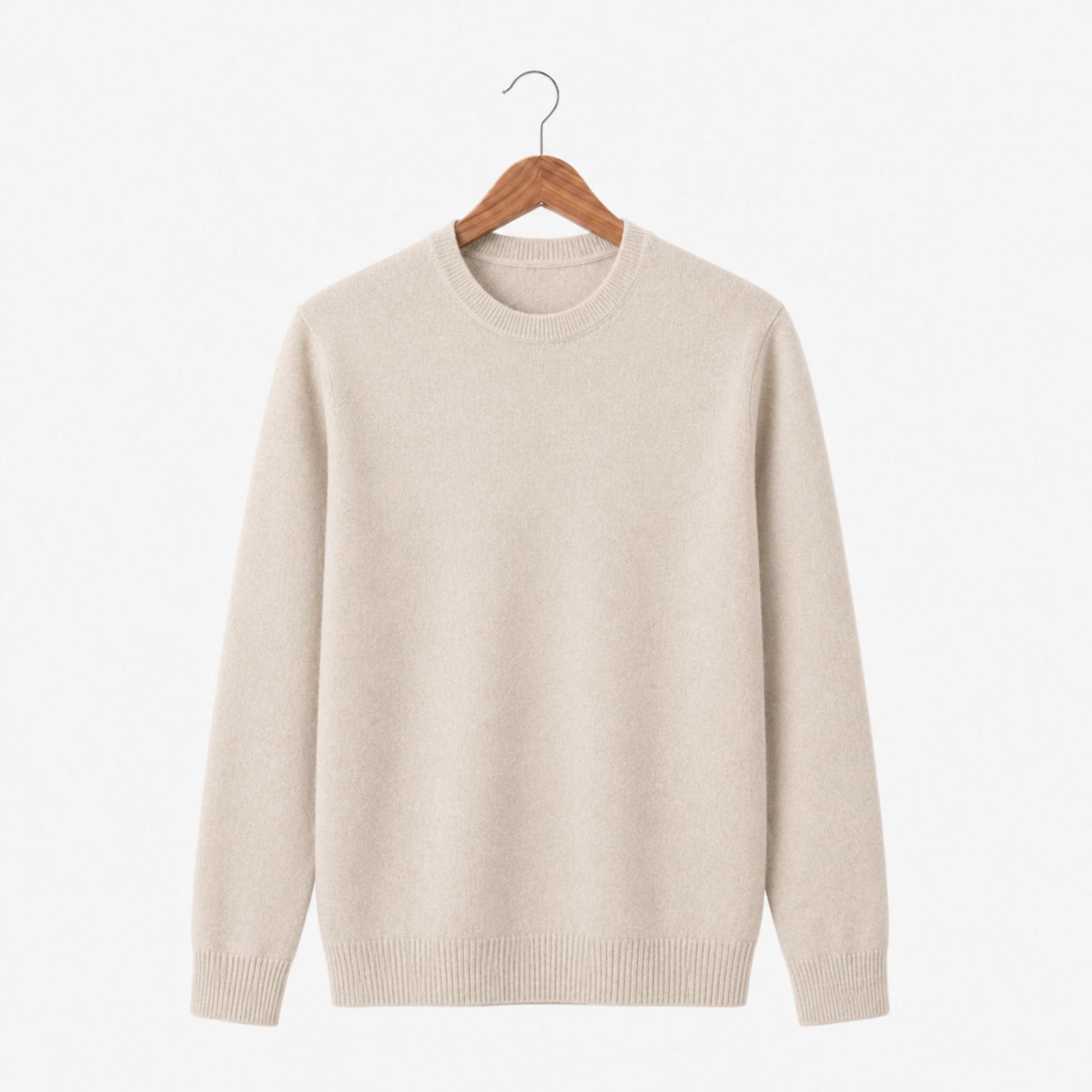 Beige sweater on a wooden hanger against a white background