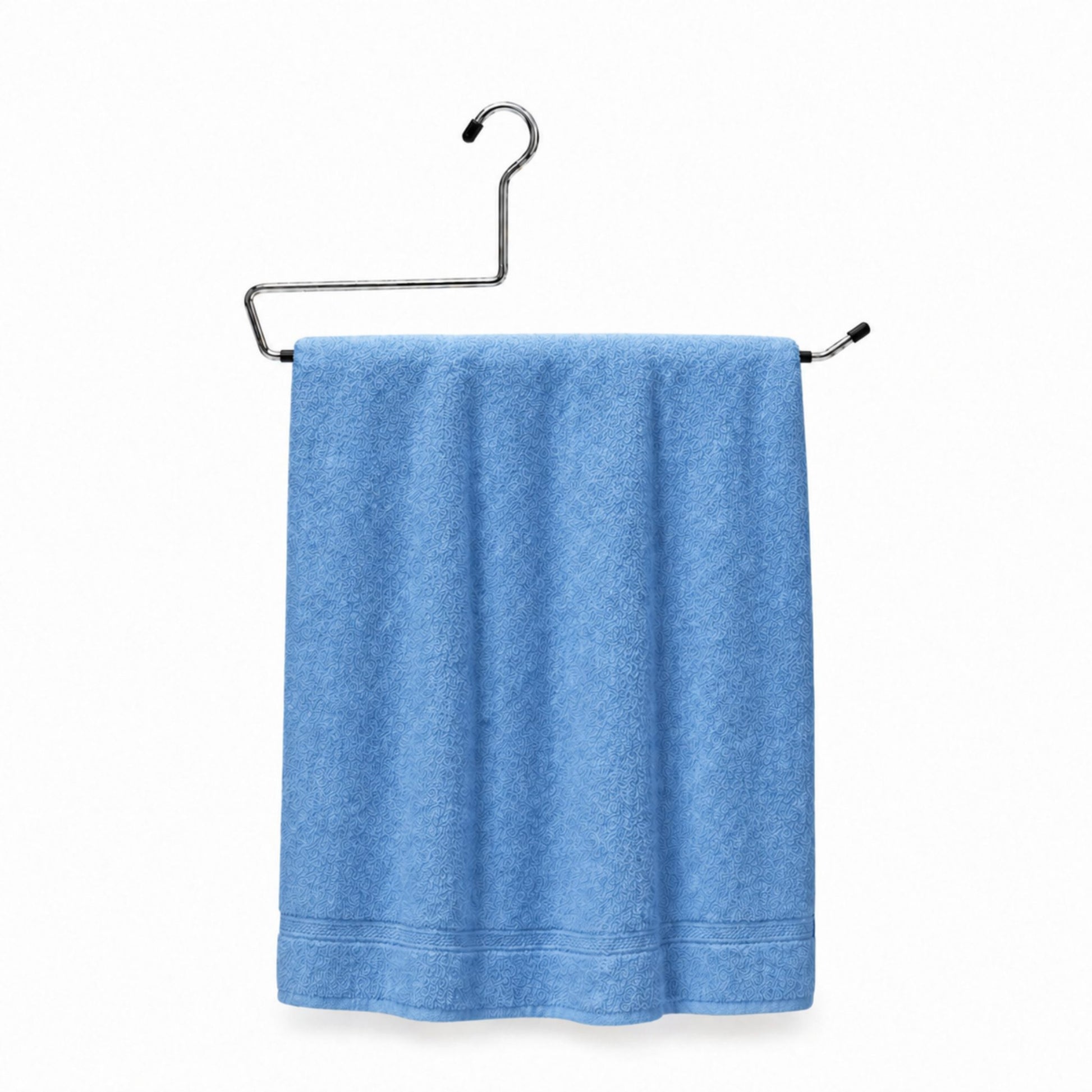 Blue towel hanging on a metal rack against a white background
