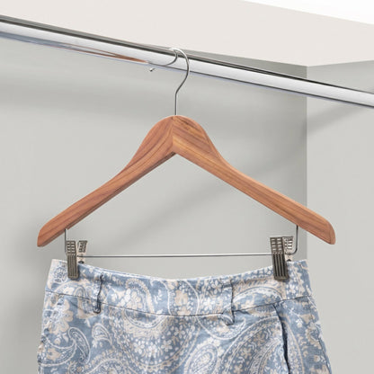 Cedar Wooden hanger with a pair of blue patterned pants on a white background