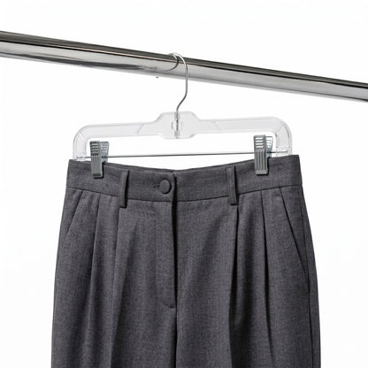 Gray pleated pants on a clear hanger against a white background