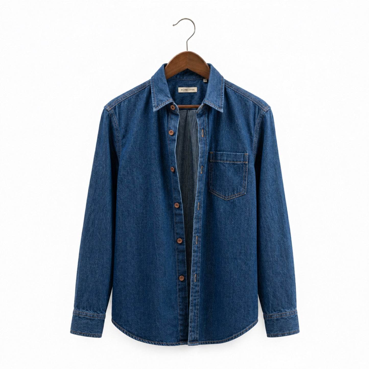 Blue denim shirt on a hanger against a white background