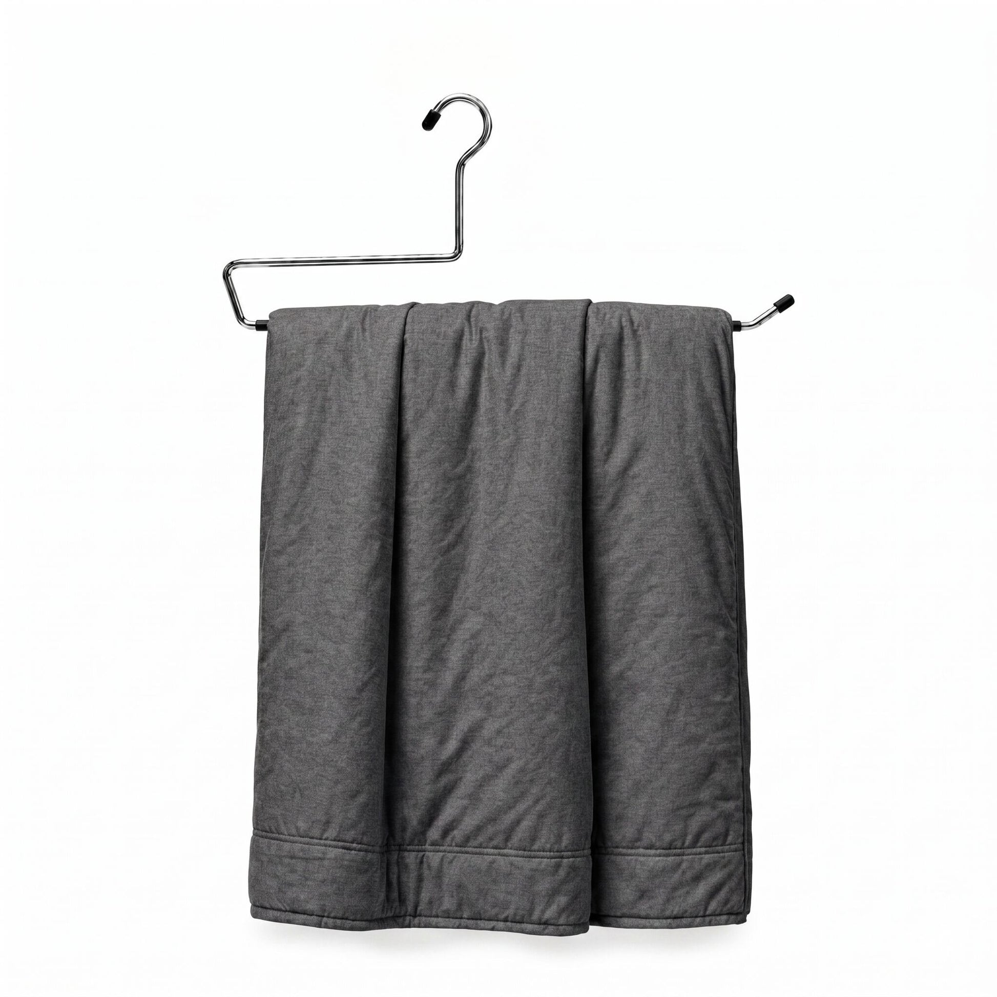 Gray towel hanging on a metal rack against a white background