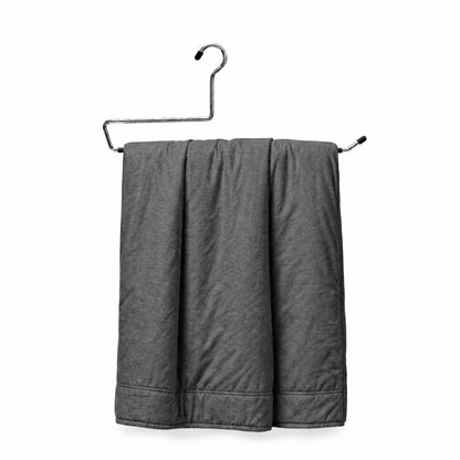 Gray towel hanging on a metal rack against a white background