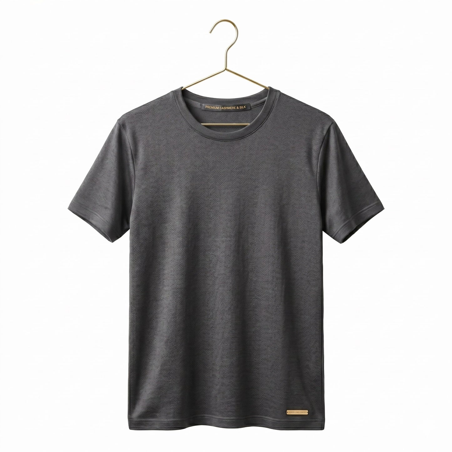 Grey short-sleeve shirt on a gold metal coat hanger against a white background