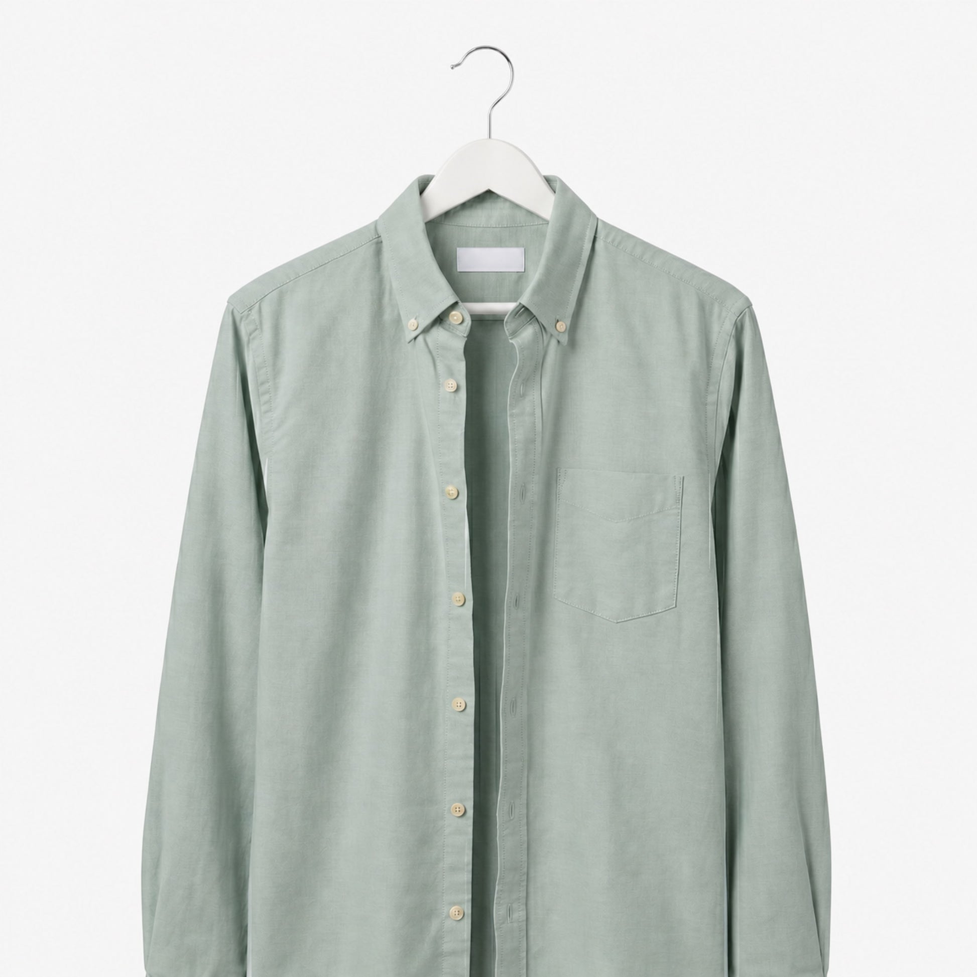 Light green shirt on a hanger against a white background