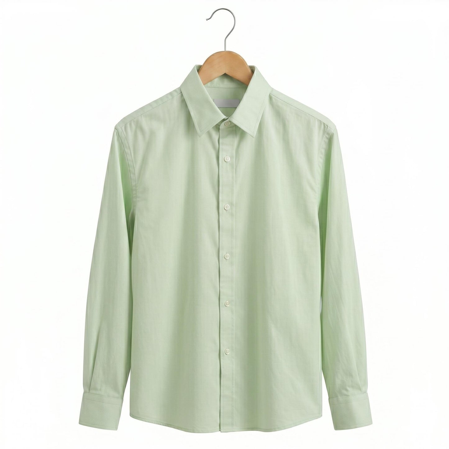 Light green shirt on a wooden hanger against a white background