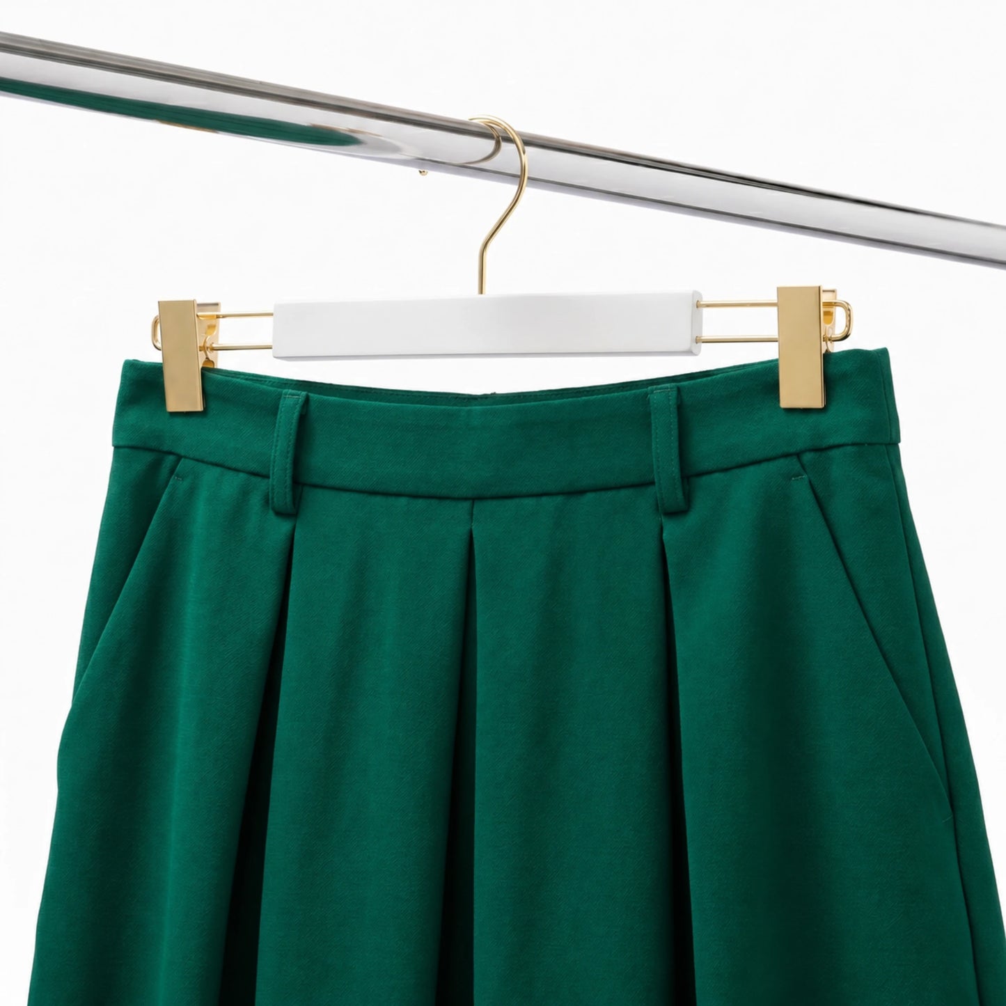 white wood coat hangers with gold hook and clips with a green skirt