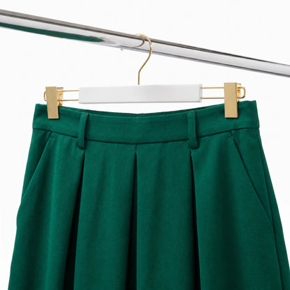 white wood coat hangers with gold hook and clips with a green skirt